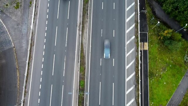 Aerial Drone Shot looking down over UK Motorway and River by Woodland (2.7K UHD)