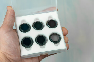 Box with filters for the drone camera in the hand of a man close-up