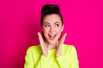 Portrait of astonished crazy sportswoman look empty space scream isolated over pink bright color background