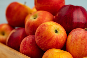 Fototapeta na wymiar Pile of red apples on wooden tray