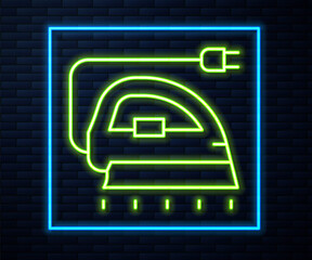 Glowing neon line Electric iron icon isolated on brick wall background. Steam iron. Vector.