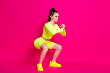 Fototapeta na wymiar Full body profile side photo of intense athletic girl doing sit-ups isolated on pink bright color background
