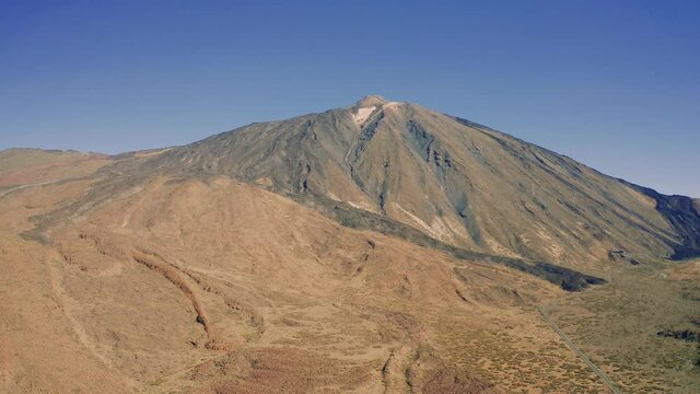4K Aerial view of volcanic landscape and lava scenery in Teide National Park - Tenerife, Canary Islands, Spain. 4K drone footage. High mountains above cloud level
