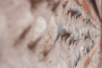 Close texture. Specific technique. Brick wall cement concrete texture with pebble background. Building materials.