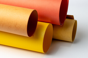 Close up image of rolled textured art papers isolated on white background