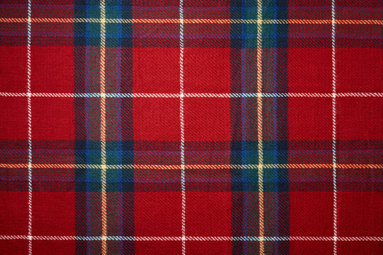 Red tartan plaid material background. Christmas pattern.