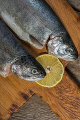 Fish, fresh trout on a cutting board, and the old wooden background