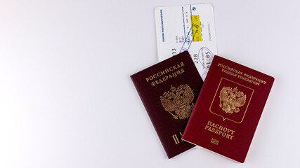 two passports with a plane ticket on a white background