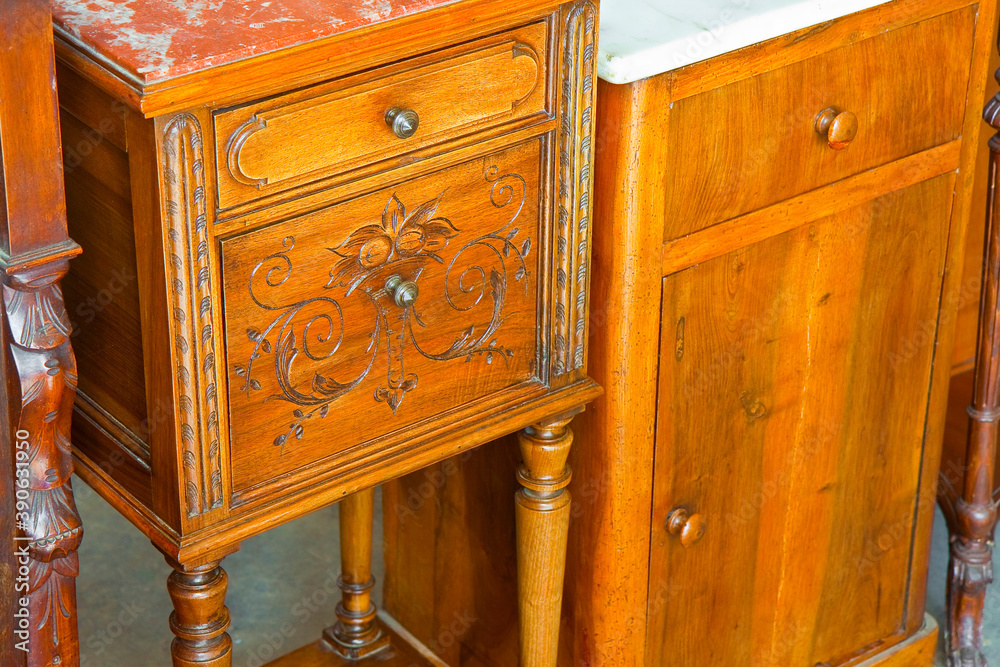 Wall mural Antique italian wooden bedside table just restored with floral decorations