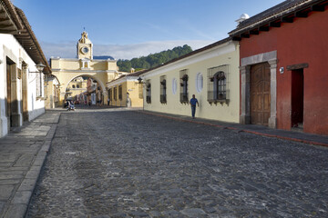 Antigua, Guatemala, Central America: Agua volcano behind yellow Santa Catalina Arch, colonial town and UNESCO World Heritage Site