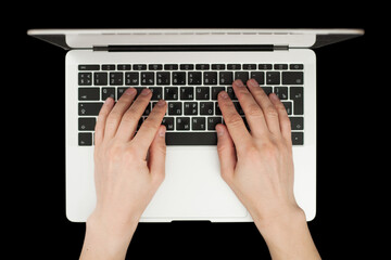 Top view of businessman hands busy using laptop at black office desk.
