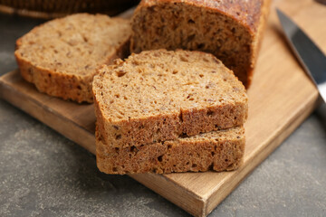 Fototapeta na wymiar Tasty freshly baked bread on grey table, closeup