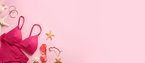 Beautiful bikini and beach accessories on pink background, flat lay. Space for text