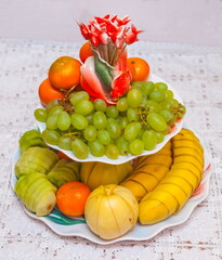 Sliced and whole fruit for two plate closeup on white background tablecloth