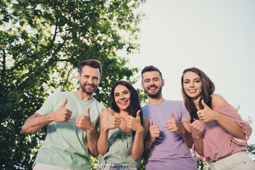 Low angle view photo of happy joyful brunette young people make thumbs up promote good weekend...