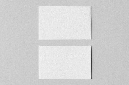 Textured business card mockup on a grey background.  85x55 mm.