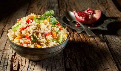 Bowl heaped with couscous and quinoa salad