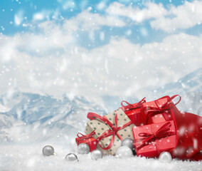 bag with red and silver gift boxes. view of the snowy mountains