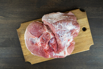 Juicy raw piece of meat on a wooden Board. The view from the top.