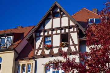 Facade of private house with open windows and tiled roof in Germany