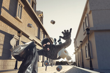 clumsy thief with flying toilet rolls slipping and falling