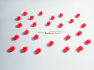 
coronavirus pathogen and thermometer on a white background