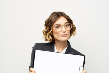 Business woman with a folder of documents on a light background cropped view and shirt suit