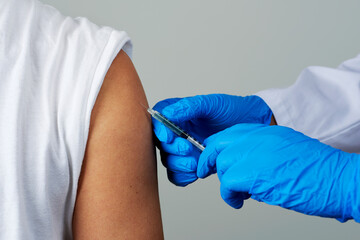 Fototapeta premium doctor man vaccinating a young man