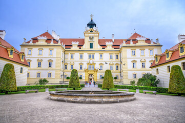 Obraz premium View of small water fountain and front facade of Valtice castle, UNESCO (Czech Republic)