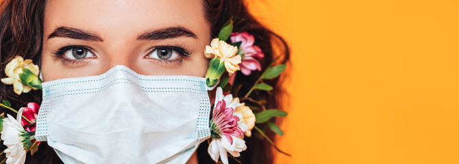 Young woman wearing a medical mask made of flowers during a pandemic