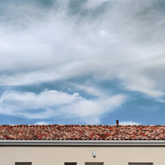 The terracotta rooftop over the blue cloudy day time sky