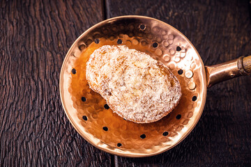 fried or baked bread with cinnamon and sugar in an antique copper skimmer. Called rabanada in brazil, portuguese gold slice in portugal and spanish torrijas in spain