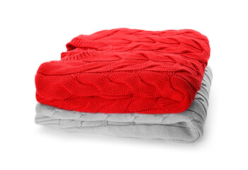 Stack of different warm sweaters isolated on white