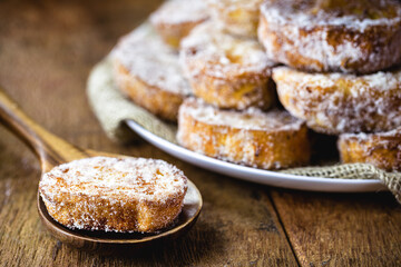 fried or baked bread with cinnamon and sugar in an antique copper skimmer. Called rabanada in brazil, portuguese gold slice in portugal and spanish torrijas in spain