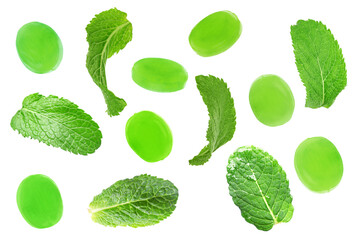 Set of mint hard candies and green leaves on white background