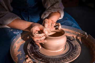 Craftsman master making ceramic pottery on wheel. Making ceramic dishes. Close-up.