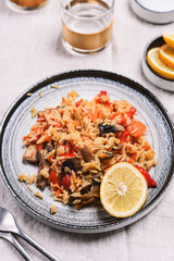 Arroz con verduras y azafran, spanish dish. Vegetarian risotto with  vegetables, champignons and saffron on beige linen tablecloth. Selective focus