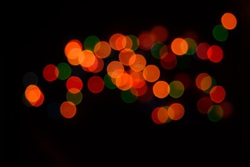 The multicolored side's or boke on a black background. Merry Christmas and happy New Year. Christmas background.