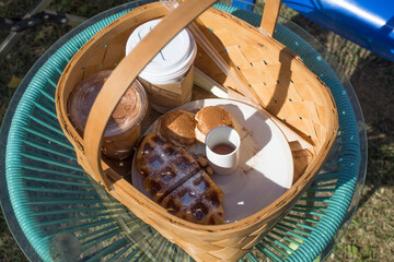 coffee and croissant waffle put on basket.