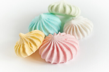 Pastel colored meringue on white background