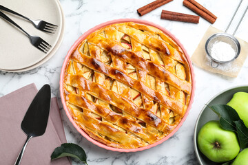 Flat lay composition with fresh traditional apple pie on white marble table