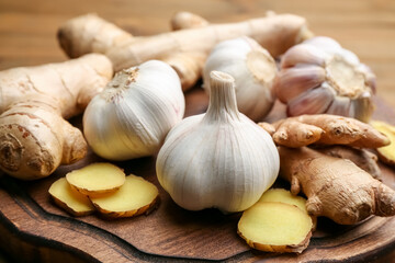 Ginger and fresh garlic on wooden board. Natural cold remedies