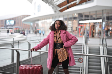 young woman with trolley in a station