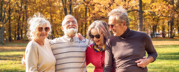Group of Senior Retirement Friends having fun in autumn park.