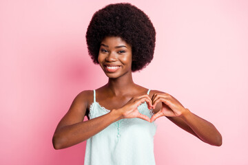 Photo of happy brown haired young woman make hands heart shape romantic mood isolated on pink color background
