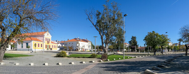 Panorama of the city center, with the municipal library and square gardens in the background, cloudless blue sky, Nisa village, Portalegre district, Alentejo region, Portugal
