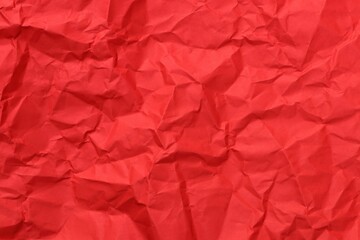 Red crumpled paper textured background.