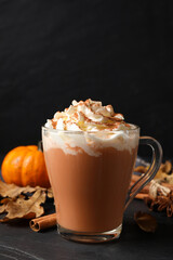 Delicious pumpkin latte on black slate table, closeup