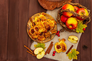 Homemade apple dessert, portioned puffs with fragrant cinnamon sticks, colorful foliage, autumn good mood