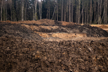 Fototapeta premium A mountain of sand at a road construction site. 